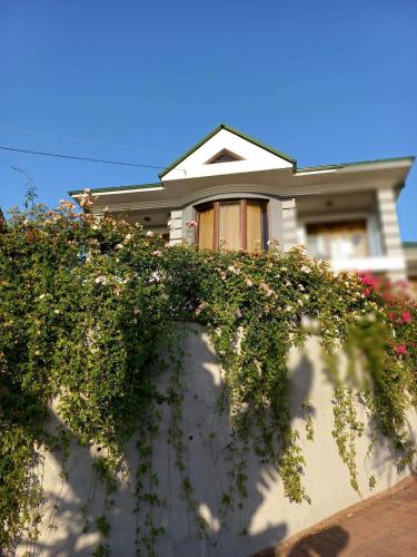 a house with flowers on the side of it at Guest House Botanical Paradise in Mtsvane Kontskhi