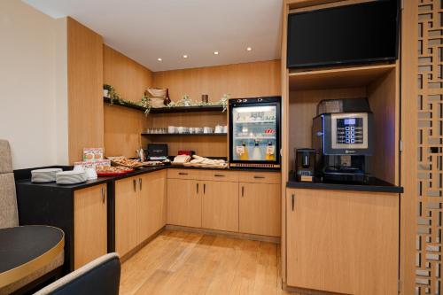 a kitchen with a drink bar with a popcorn machine at Sonder Le Frochot in Paris