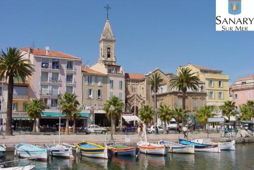 a group of boats sitting in the water in a city at Chez Louise et Lucette in Sanary-sur-Mer