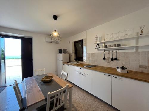 a kitchen with a table and a dining room at Gorgo Rinaldi - Locazioni brevi in Monopoli