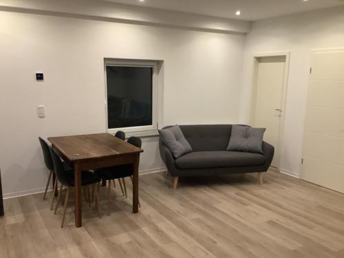 a living room with a couch and a table at Ruhige Nachbarschaft in Hamminkeln