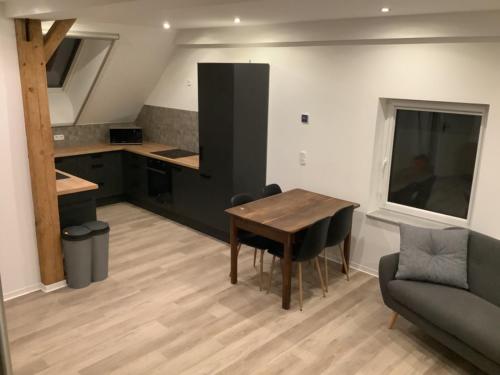 a kitchen and dining room with a table and a couch at Ruhige Nachbarschaft in Hamminkeln