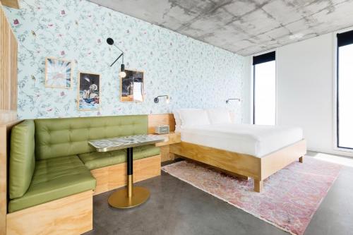 a bedroom with a bed and a green couch at ARRIVE Austin in Austin