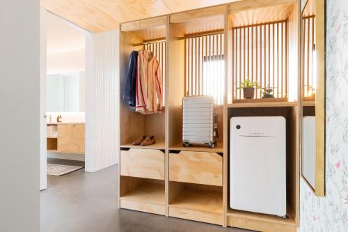 a closet with a white refrigerator in a room at ARRIVE Austin in Austin