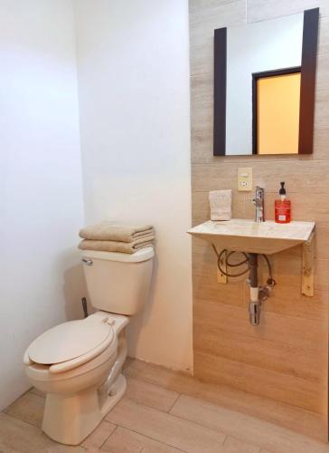 a bathroom with a toilet and a sink at Vacacional Azueta - Departamento a unos pasos de la playa in Mazatlán