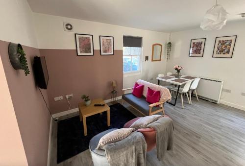 a living room with a couch and a table at Sunnyside Studio in Worthing