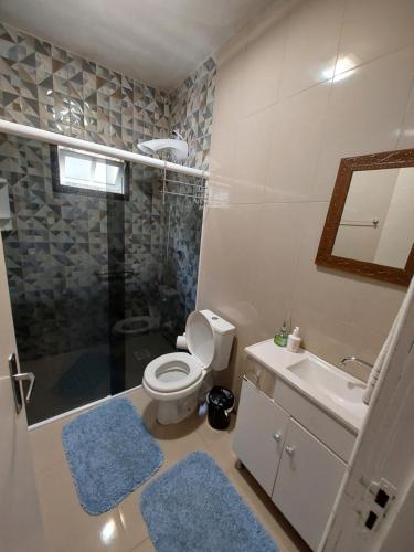 a bathroom with a toilet and a sink and a shower at Harmonia Haus in Blumenau