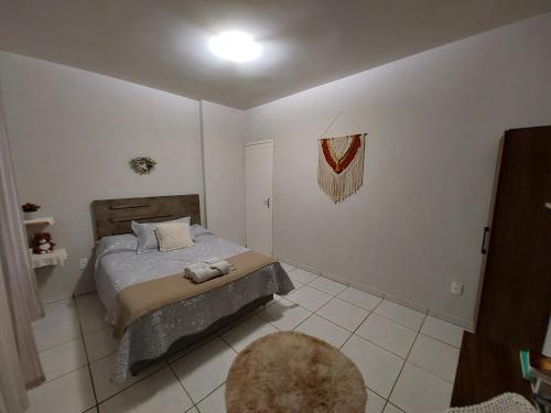 a bedroom with a bed and a rug at Harmonia Haus in Blumenau