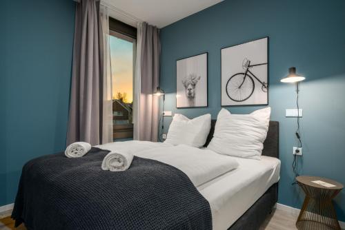 a bedroom with a bed with a bike on the wall at BRIGHT Lippstadt Klusetor in Lippstadt