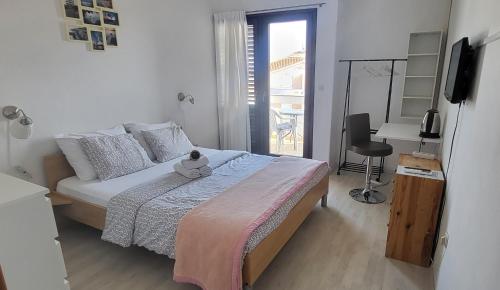 a bedroom with a bed with a teddy bear on it at Villa Finera in Premantura