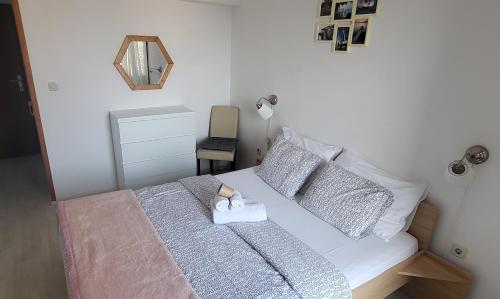 a small bedroom with a white bed with a candle on it at Villa Finera in Premantura