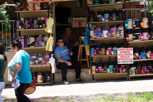 a man sitting on a shelf in a store at Casa Charlie in Areguá