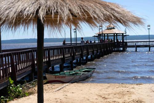 a boat sitting on the beach next to a pier at Casa Charlie in Areguá