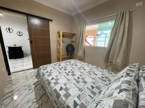 a bedroom with a bed and a window at Flat 2 Marias in Maragogi