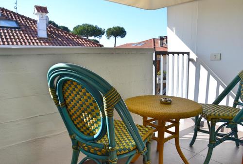 a table and chairs on a balcony with a table and a chair at Hotel Tiffany in Marina di Massa