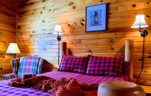 a bedroom with a bed with two chairs and two lamps at NewVida Preserve in Wilmington