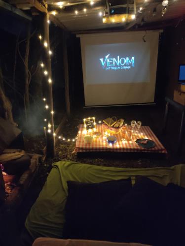 a stage with a screen and a table with shoes on it at Iwoka Ecoturismo in La Calera