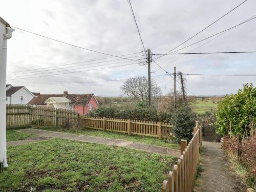 a wooden fence in front of a yard at Celia's View in Langport