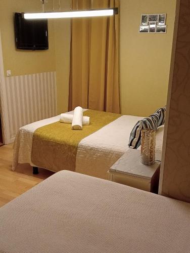 a hotel room with two beds and a mirror at Tu Mansión in Navalcarnero