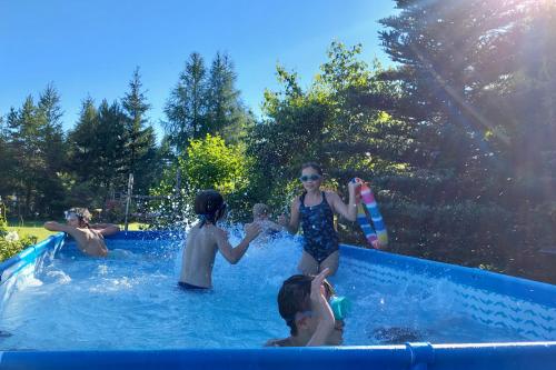 a group of people playing in a swimming pool at Agroturystyka Pod Modrzewiem - Babia Góra in Zubrzyca Górna