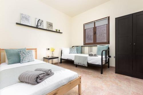 1 dormitorio con 2 camas y sofá en Casa El Kornao, Fuerteventura, en Tuineje
