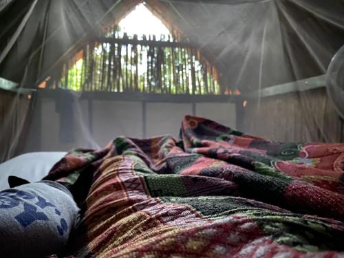 a pile of blankets laying on top of a tent at BONITA HOSTEL in Palomino