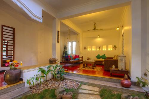 
a living room filled with furniture and a window at The Fort Bungalow in Cochin
