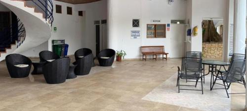 a room with chairs and tables and a staircase at Condominio, Cabaña 202 in Puerto Viejo