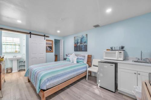 a bedroom with a bed and a kitchen with a microwave at Largo Retreat in Largo