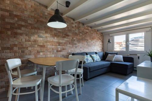 a living room with a couch and a table and chairs at Apartamento Sanxenxo Centro in Sanxenxo