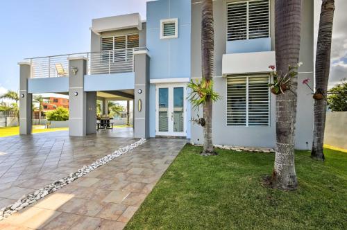 a house with palm trees in front of it at Oceanside Vega Baja Beach House Paradise with Views! in Vega Baja