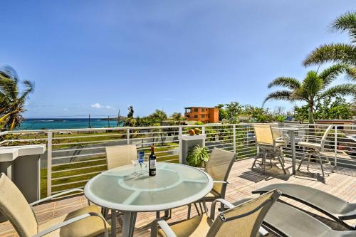a patio with a table and chairs and the ocean at Oceanside Vega Baja Beach House Paradise with Views! in Vega Baja
