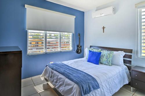 a blue bedroom with a bed with blue walls at Oceanside Vega Baja Beach House Paradise with Views! in Vega Baja