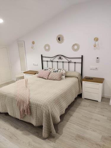 a bedroom with a large bed and a wooden floor at A casa dos Pobres in Muxia