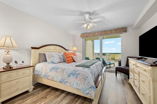 a bedroom with a bed and a flat screen tv at Apollo #210 in Marco Island