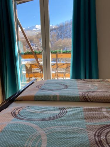 a bed in a room with a large window at Blue Lagoon Apartments in Crni Vrh