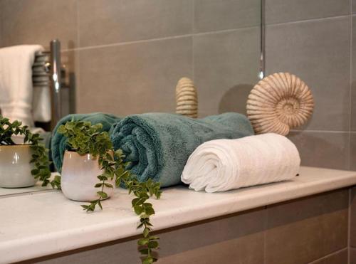 a towel sitting on a shelf in a bathroom at Luxury Modern, One bedroom flat in Solihull