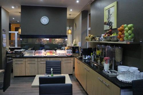 a large kitchen with a counter with a clock on the wall at Hotel Columbus in Frankfurt