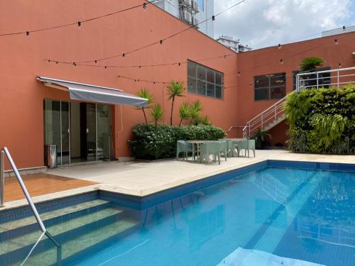 a swimming pool in front of a building at ibis Styles Belem Nazare in Belém