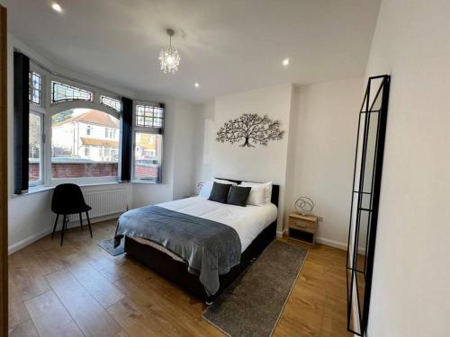 a bedroom with a bed and a large window at Luxury Apartment in Nuneaton in Nuneaton