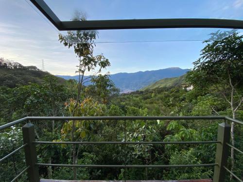 a view from the balcony of a house in the mountains at ANCESTRAL GLAMPING in Barbosa