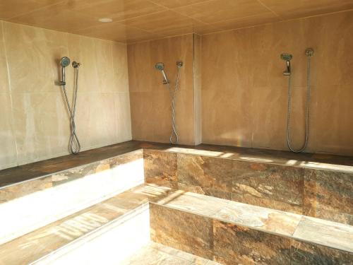 a bathroom with two shower heads on the wall at Apartamento Frente al Mar in Santa Marta