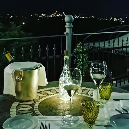 a table with wine glasses and a bottle of wine at Relais Todini - Residenza d'epoca - Luxury Historic house in Todi