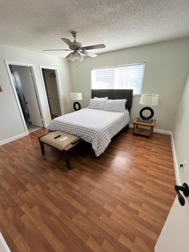 a bedroom with a bed and a ceiling fan at Cheerful 3 Bedroom Home mins from Clearwater Beach in Clearwater