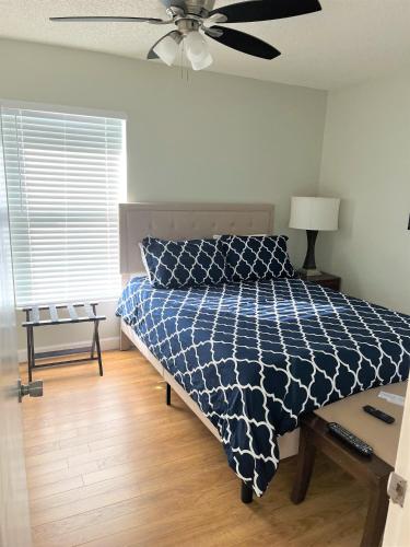 a bedroom with a bed and a ceiling fan at Cheerful 3 Bedroom Home mins from Clearwater Beach in Clearwater