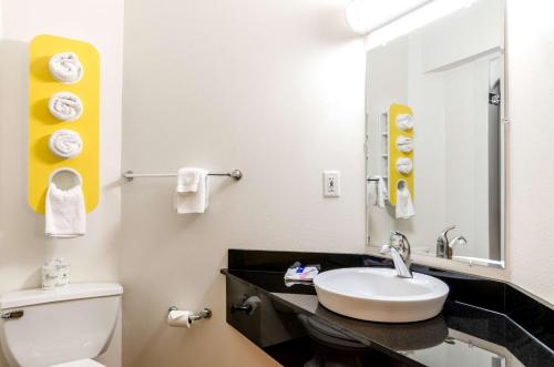 a bathroom with a white toilet and a sink at Motel 6 Savannah, GA - Gateway & I-95 in Savannah