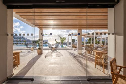 a view of the pool from the lobby of a resort at Radisson Blu Resort, Lanzarote Adults Only in Costa Teguise