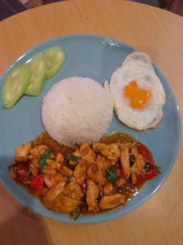 a plate of food with shrimp and an egg and rice at Golden Monkey Samui in Koh Samui 