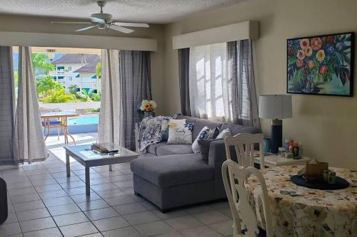 a living room with a couch and a table at Chalet Cassie in Montego Bay