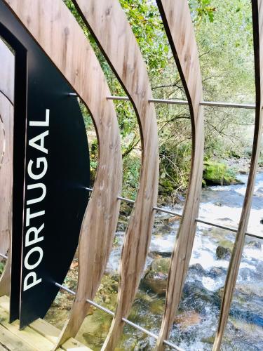 a wooden bridge with a river under it at Casa 1883 in Cevide